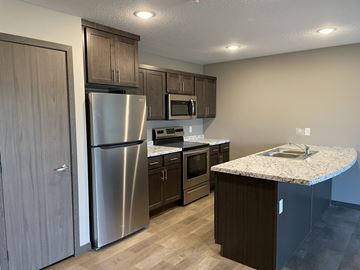 Sleepy Eye apartment for rent - a kitchen with stainless steel appliances and a marble counter top