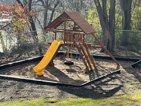 Brainerd apartment for rent - A wooden playground with a yellow slide.