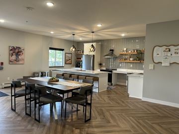 Cambridge apartment for rent - A kitchen with a table and chairs in the foreground and a refrigerator in the background.