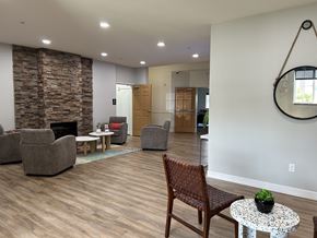 Cambridge apartment for rent - A living room with a stone fireplace and a wooden chair.