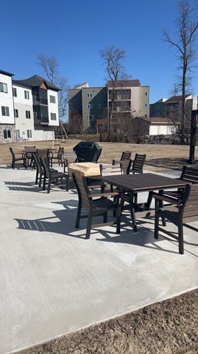 Alexandria apartment for rent - A park with a table and chairs in the foreground and apartment buildings in the background.