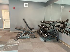Annandale apartment for rent - A gym with a bench, weights, and mirrors.