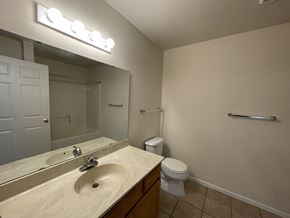 Fergus Falls apartment for rent - A bathroom with a sink, toilet, and mirror.