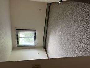 Pierz apartment for rent - A window with blinds is on the left side of a room with a textured wall.