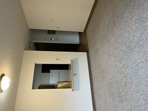 Pierz apartment for rent - A small mirror on a wall reflects a cabinet and a shelf.