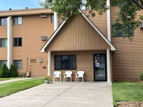 Pierz apartment for rent - A brown house with a white chair in front.