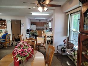 Hawley apartment for rent - A dining room with a table and chairs and a woman sitting in a chair.
