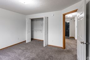 Isanti apartment for rent - BLDG A/C - A room with a white door and a grey carpet.