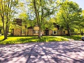Little Falls apartment for rent - A house with a driveway and trees in front of it.