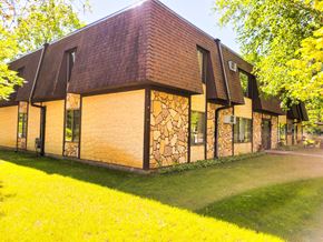 Little Falls apartment for rent - A house with a brown roof and stone walls.