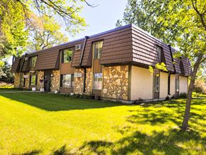 Little Falls apartment for rent - A house with a brown roof and a stone wall.