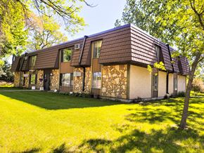 Little Falls apartment for rent - A house with a brown roof and a stone wall.