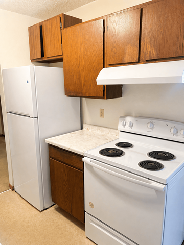 Little Falls apartment for rent - A white fridge and stove in a kitchen.