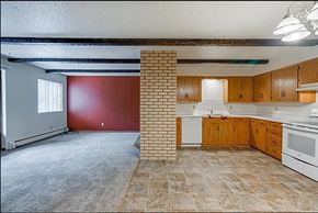 Sartell apartment for rent - A kitchen with wooden cabinets and a tiled floor.