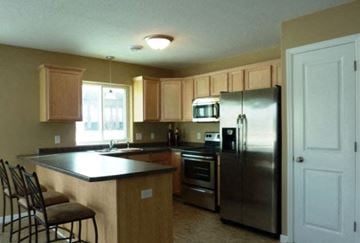 Mankato townhouse for rent - a kitchen with a counter top and a refrigerator