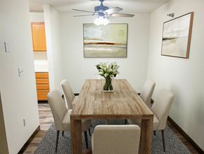 Byron apartment for rent - A dining room with a wooden table and chairs.