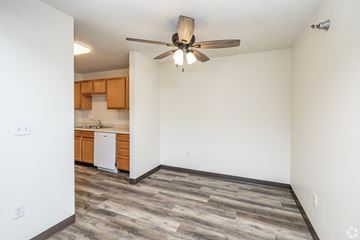 Byron apartment for rent - A room with a ceiling fan and a dishwasher in the kitchen area.