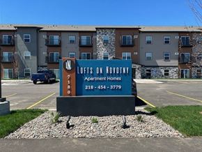 Baxter apartment for rent - a sign in a parking lot in front of an apartment building