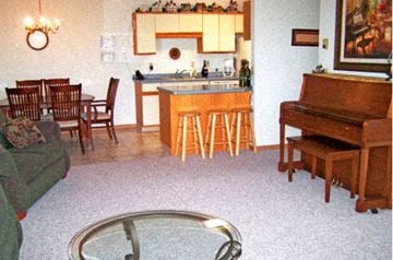 Sauk Rapids apartment for rent - A living room with a piano and a bar.