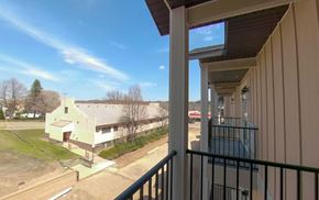Fairibault apartment for rent - a balcony with a view of a building and a street