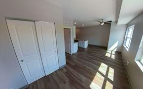 Fairibault apartment for rent - an empty living room with wooden floors and a ceiling fan