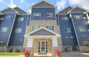 Clearwater apartment for rent - an image of a building with blue siding and a stone facade