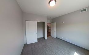 Fairibault apartment for rent - a bedroom with a carpeted floor and a door to a closet