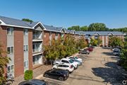 Apple Valley apartment for rent - A parking lot with cars and apartment buildings in the background.