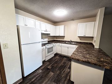 St Cloud apartment for rent - A kitchen with white appliances and cabinets.