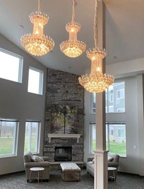 Cambridge apartment for rent - a living room with a fireplace and three chandeliers