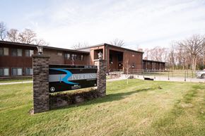 Milaca apartment for rent - A sign for River Bend is in front of a building.