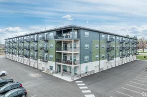 Faribault apartment for rent - a large apartment building in a parking lot