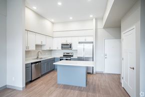 Faribault apartment for rent - a large kitchen with white cabinets and stainless steel appliances
