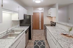St Cloud apartment for rent - A kitchen with granite countertops and white cabinets.