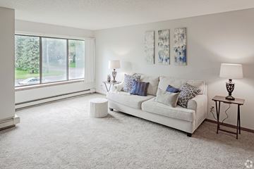 St Cloud apartment for rent - A living room with a white couch and two lamps.