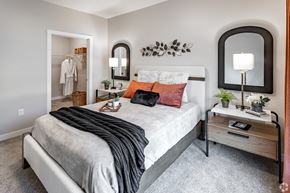 Monticello apartment for rent - a bedroom with a bed and a mirror on the wall