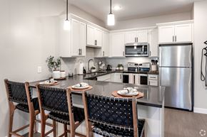 Monticello apartment for rent - spacious kitchen with stainless steel appliances and a island with chairs