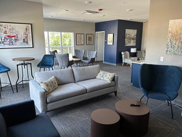 Kasson apartment for rent - a living room with a couch and tables and chairs
