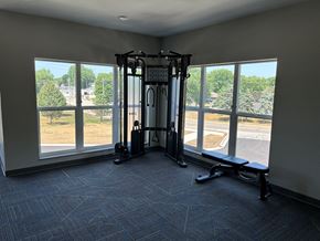 Kasson apartment for rent - a gym with large windows in the corner of a room