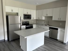 Kasson apartment for rent - a kitchen with white cabinets and stainless steel appliances