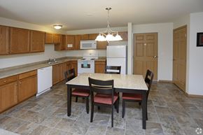 Alexandria apartment for rent - A kitchen with a table and chairs in the middle.