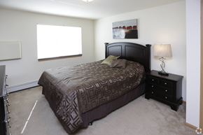 Alexandria apartment for rent - A bedroom with a large bed and a nightstand with a lamp.
