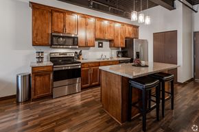 St Cloud apartment for rent - a kitchen with wooden cabinets and stainless steel appliances