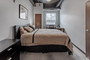 St Cloud apartment for rent - a bedroom with a bed and a dresser and a window