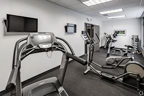 St Cloud apartment for rent - a gym with various exercise machines and a tv