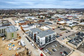 Owatonna apartment for rent - A construction site is visible in the foreground of a busy parking lot.