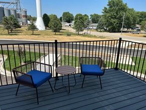 Kasson apartment for rent - a patio with two chairs and a table on a balcony