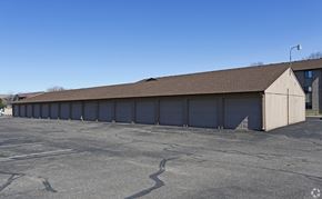 Albertville apartment for rent - A large, empty parking lot with a long building in the background.