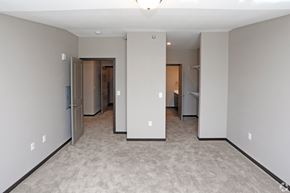 St Cloud apartment for rent - a bedroom with a carpeted floor and several closets and mirrors