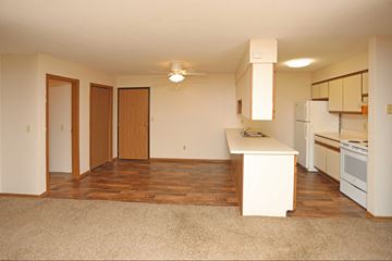 St Cloud apartment for rent - A kitchen with white appliances and wooden floors.